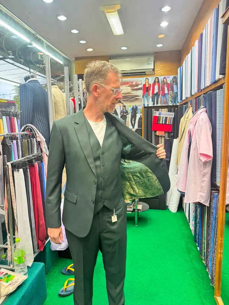 Client in an olive three-piece bespoke suit